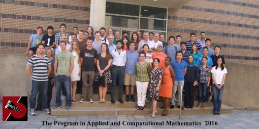 Large group of students posing for picture in front of school 